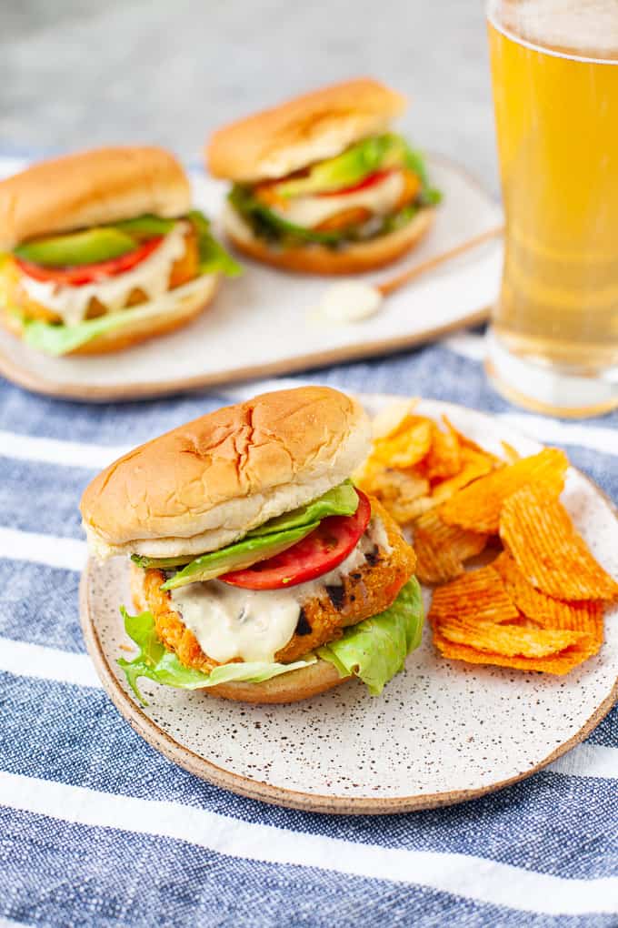 buffalo chickpea burger with lettuce, tomato, and avocado and potato chips