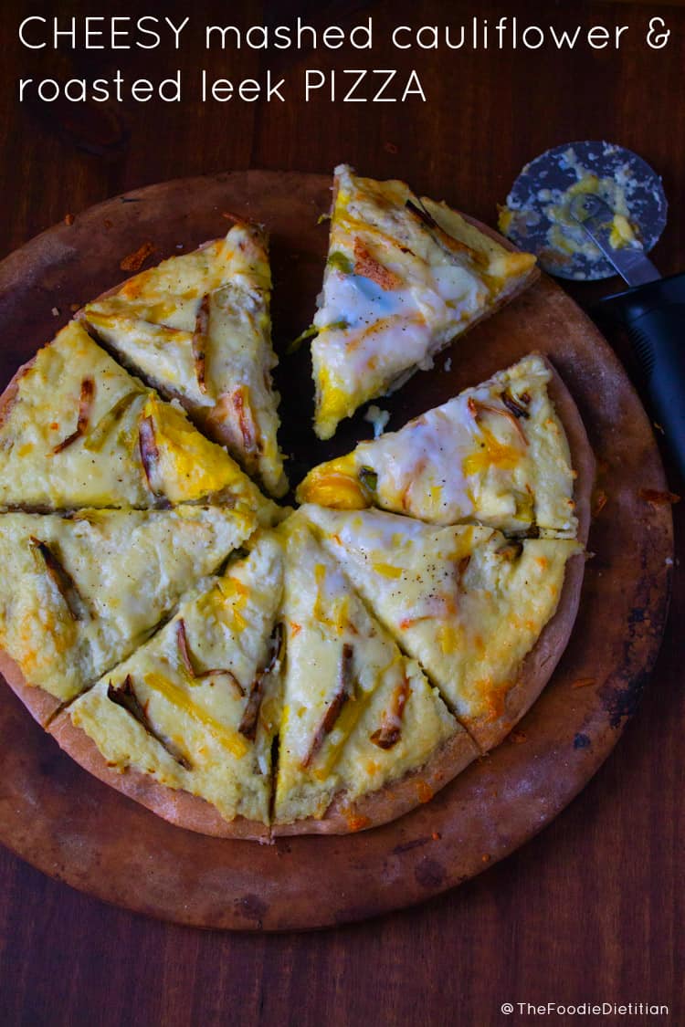 Cheesy mashed cauliflower roasted leek pizza is the ultimate game-day appetizer. It tastes hearty and indulgent but is loaded with veggies! | @TheFoodieDietitian