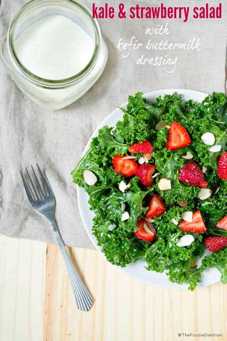 A delicious way to use kefir! Kale and strawberry salad with kefir buttermilk dressing is a great salad to bring to your next picnic or cookout! | @TheFoodieDietitian