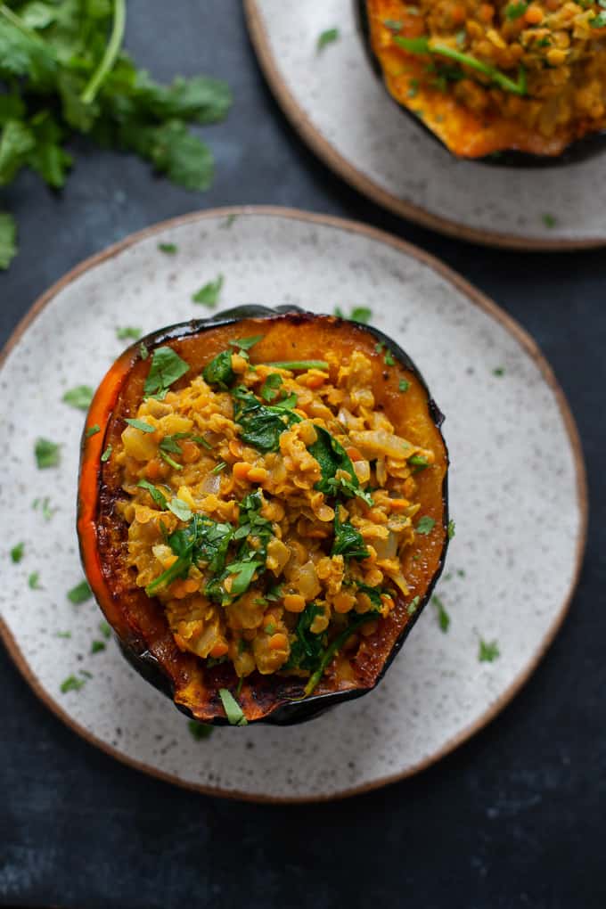 Packed with warming, cozy spices, this stuffed acorn squash with curried lentils is a perfect dinner for the chilly fall season.