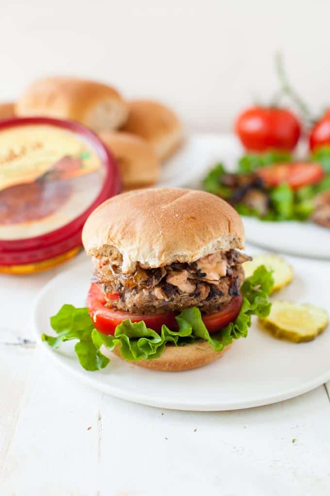 A veggie burger that packs in a lot of flavor and nutrition, this spicy hummus black bean veggie burger is perfect for summertime grilling.