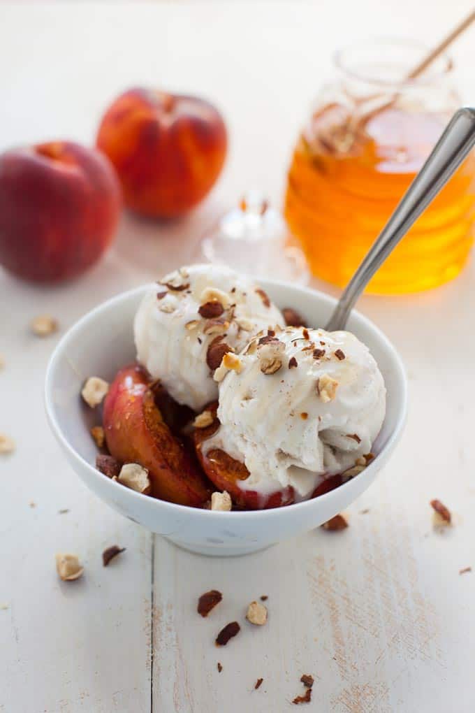 Rich, creamy, sweet and dairy-free! This vegan roasted peach ice cream sundae is the dessert you need to make summer last as long as humanly possible. 