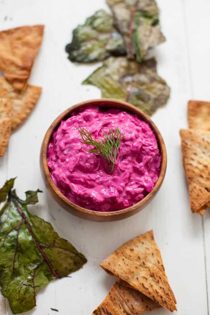 Nutrition packed and vibrant in color, this creamy, delicious beet tzatziki is one not to miss. Bonus points for using the whole beet plant to make beet green chips to go with!