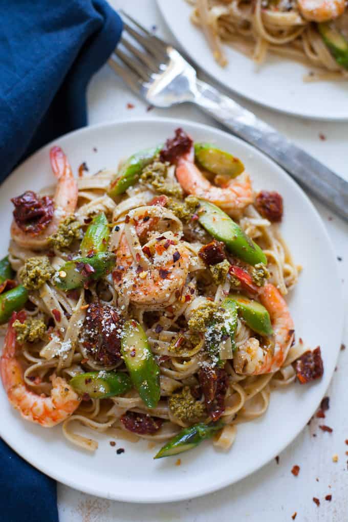 This easy shrimp pesto pasta with asparagus and sun-dried tomato is super easy to make for a quick weeknight dinner.