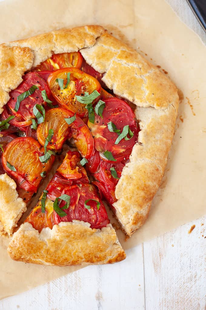 Easy, delicious and perfectly savory, this heirloom tomato basil galette with goat cheese is basically a fancier version of pizza. Pie for dinner? Need I say more?
