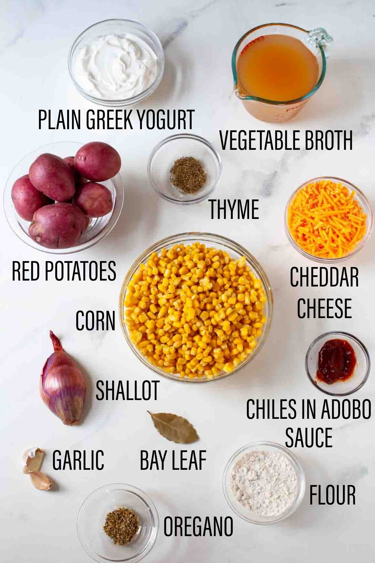 ingredients for corn potato chowder on marble surface with black text overlay