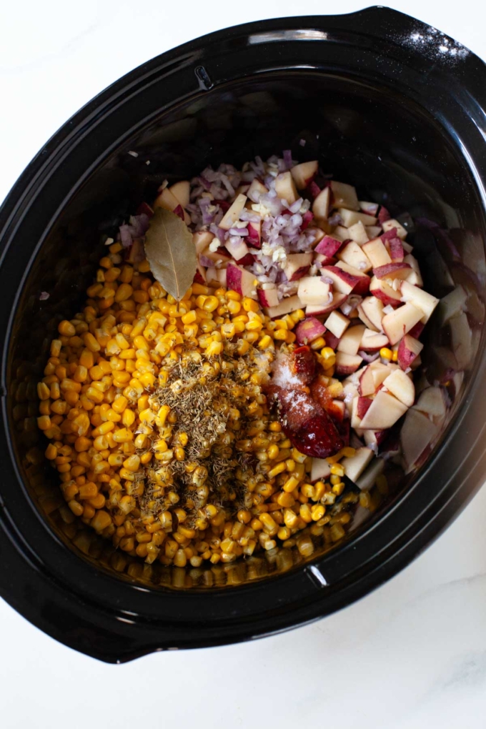 potato, corn, dried herbs, shallot and chipotle chiles in black slow cooker