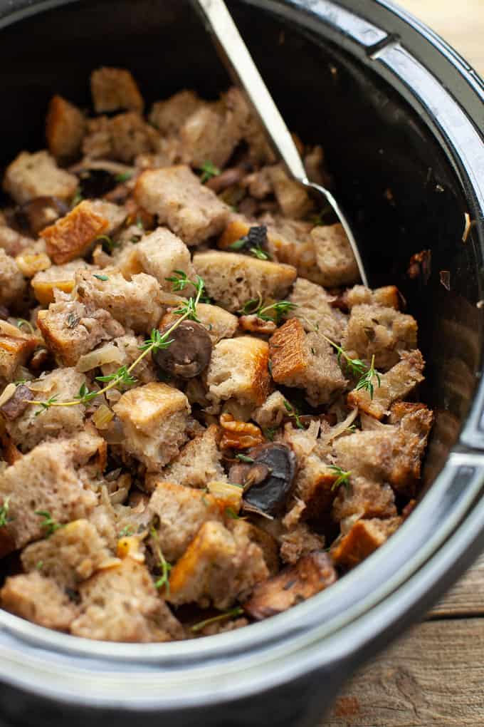 A delicious, savory, umami-filled side dish, this slow cooker mushroom stuffing will not take up any oven space on Thanksgiving! #thanksgiving #stuffing #mushrooms