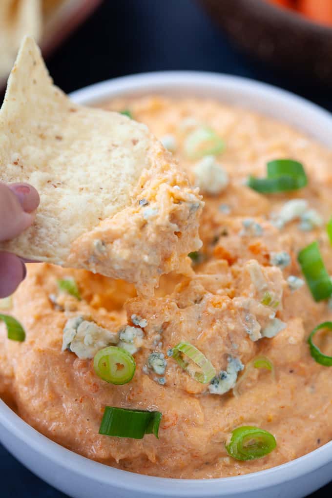 tortilla chip dipped in cauliflower wing dip