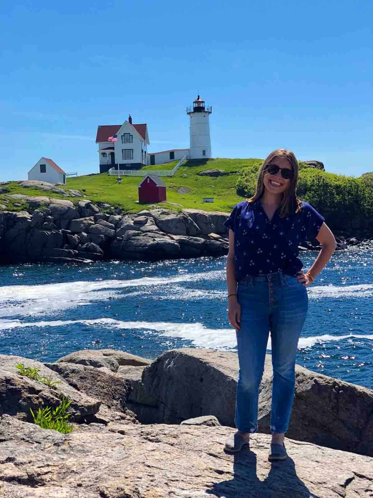 Kara posing in front of a lighthouse in Maine