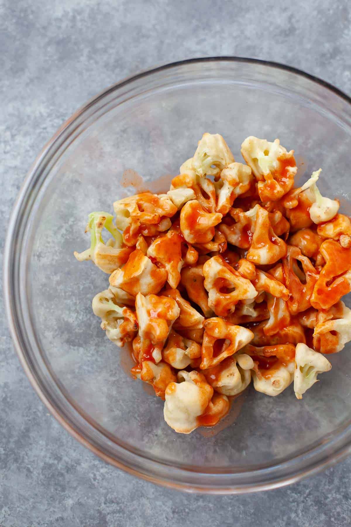 Cauliflower pieces with buffalo sauced drizzled on top