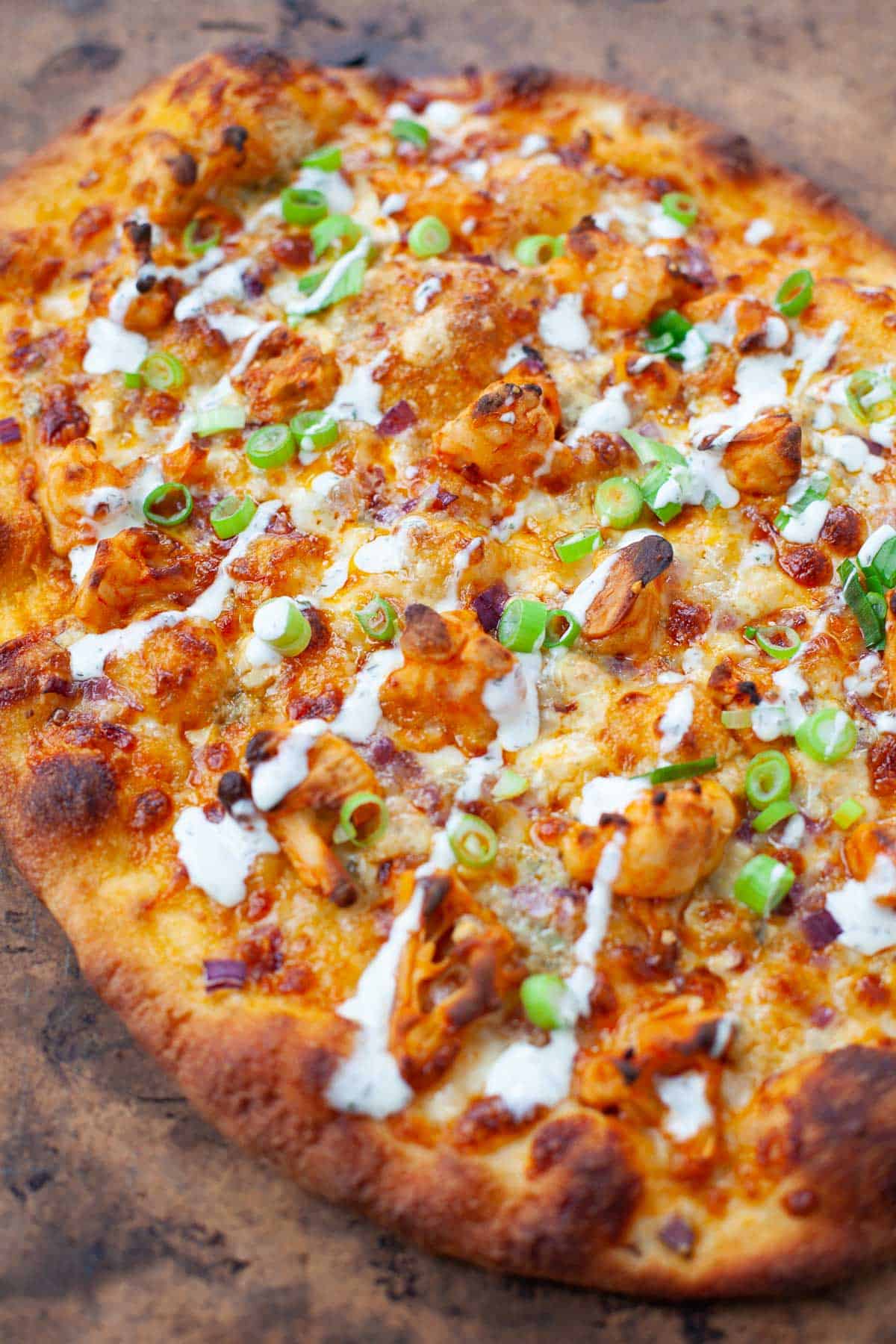 Buffalo cauliflower pizza served fresh out of the oven