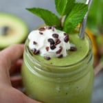 healthy shamrock shake smoothie with whipped topping and cacao garnish