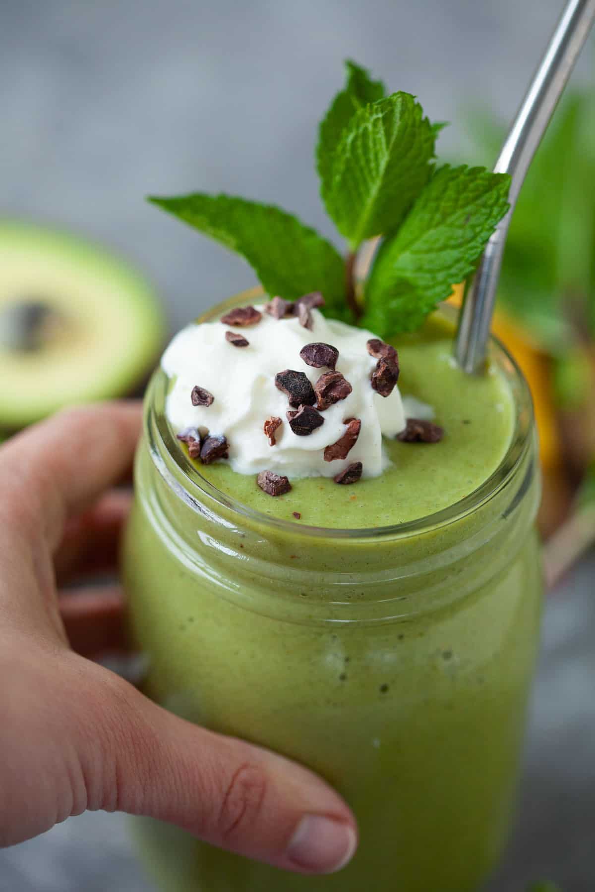 shamrock shake smoothie with whipped topping and cacao nibs for garnish