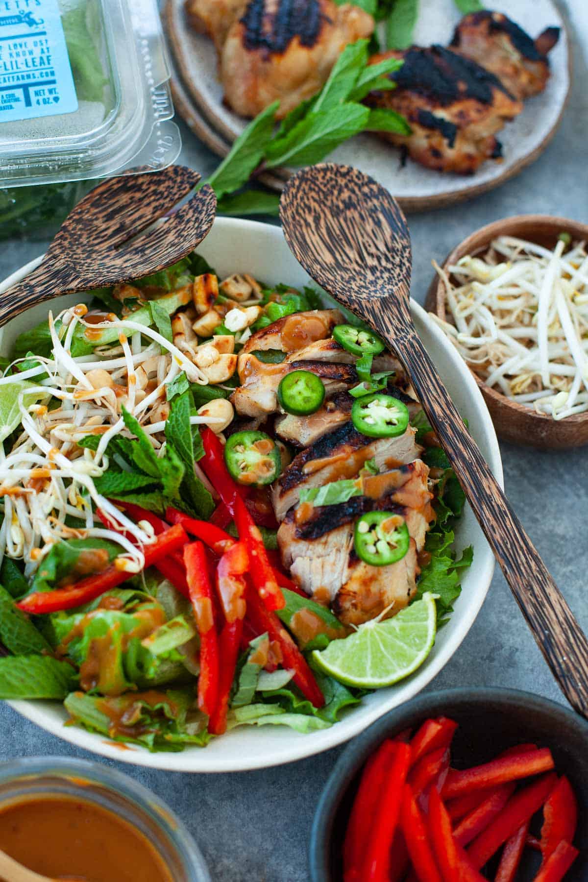tossed thai chicken salad with fresh greens and veggies