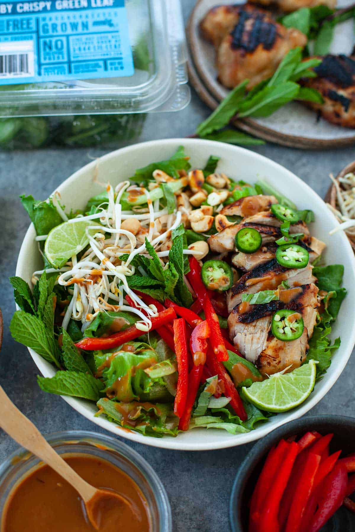 tossed thai chicken salad with fresh greens and veggies