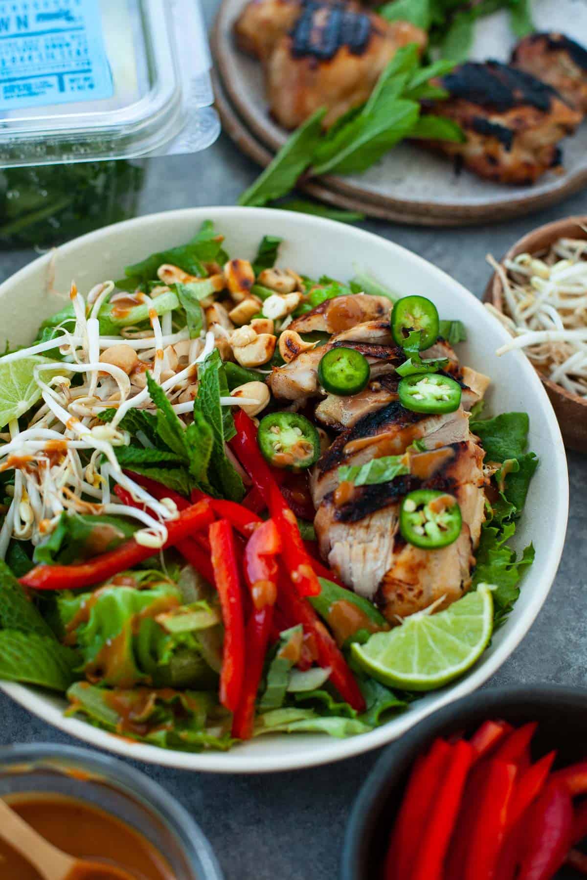 tossed thai chicken salad with fresh greens and veggies