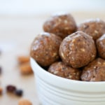 close up view of a batch of almond butter jelly energy balls in a white bowl