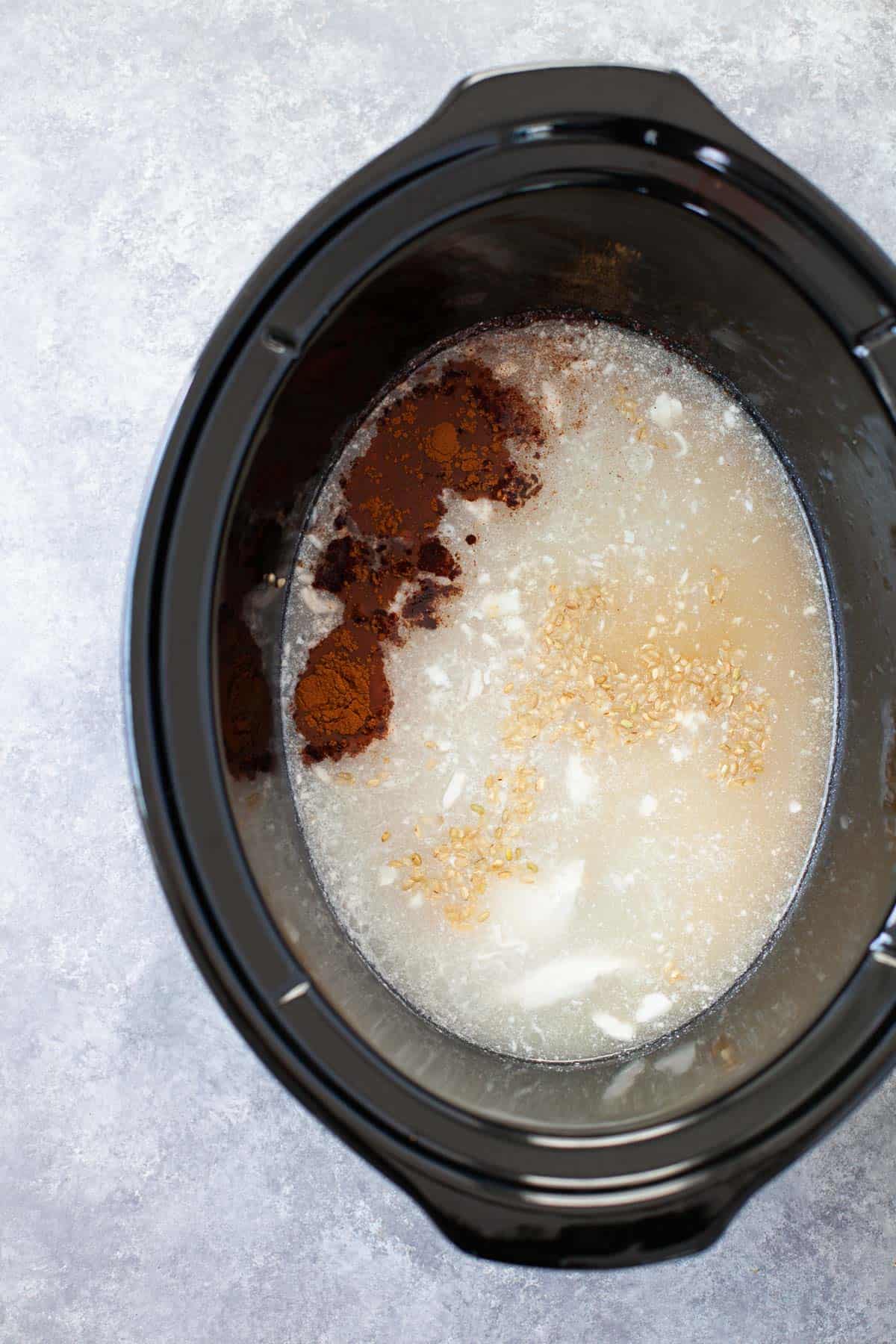 brown rice, coconut milk, and cinnamon placed in a slow cooker
