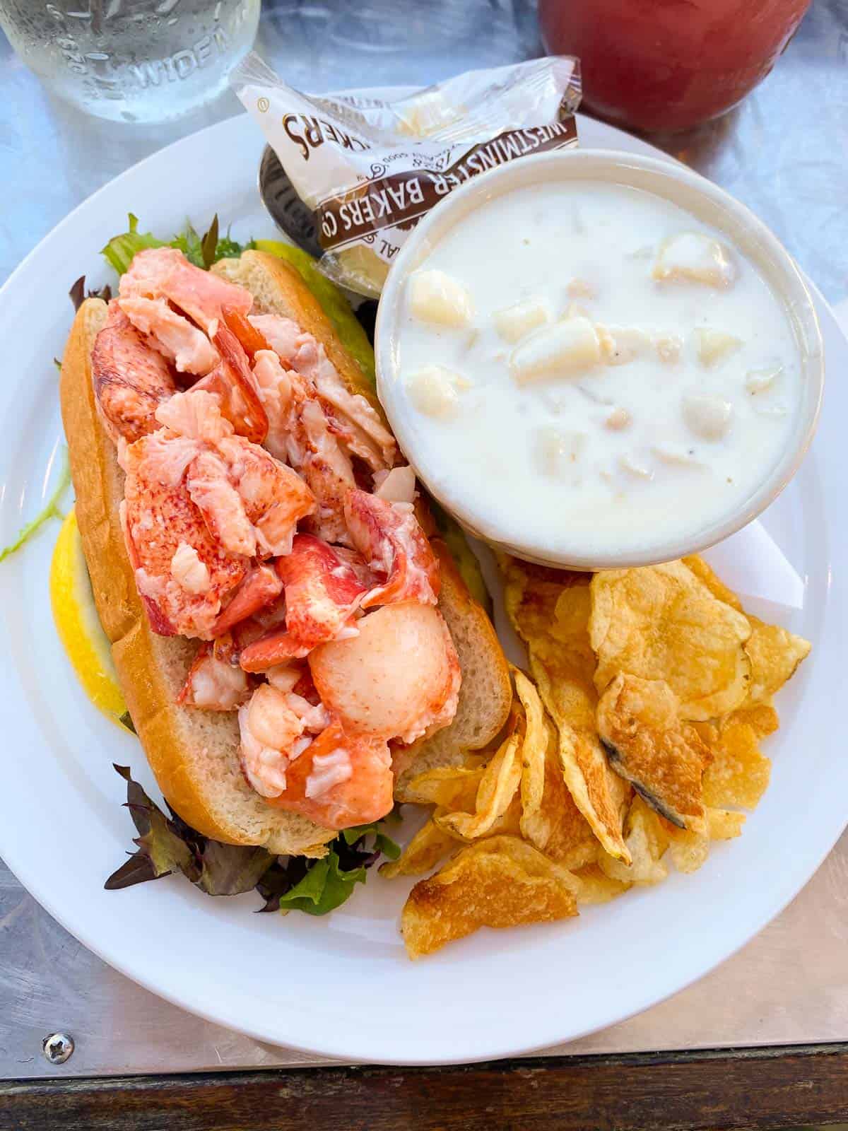 lobster roll served with clam chowder and chips