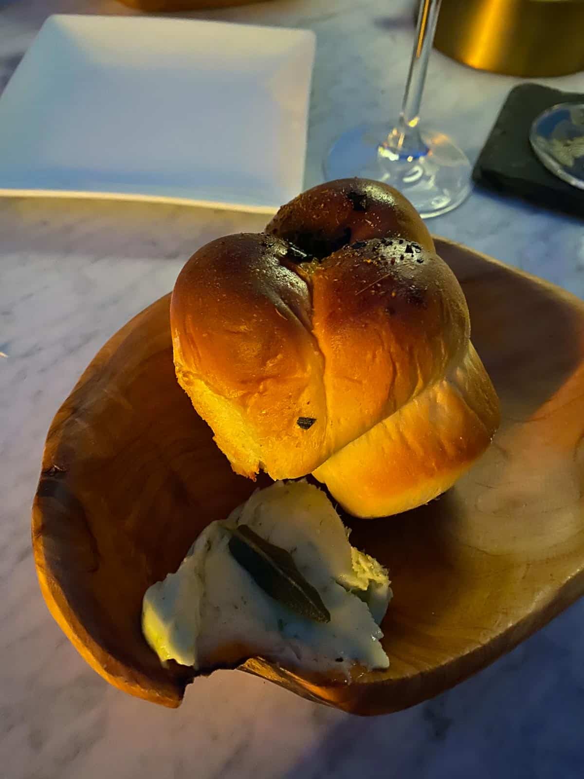 fresh bread and butter on a wooden plate