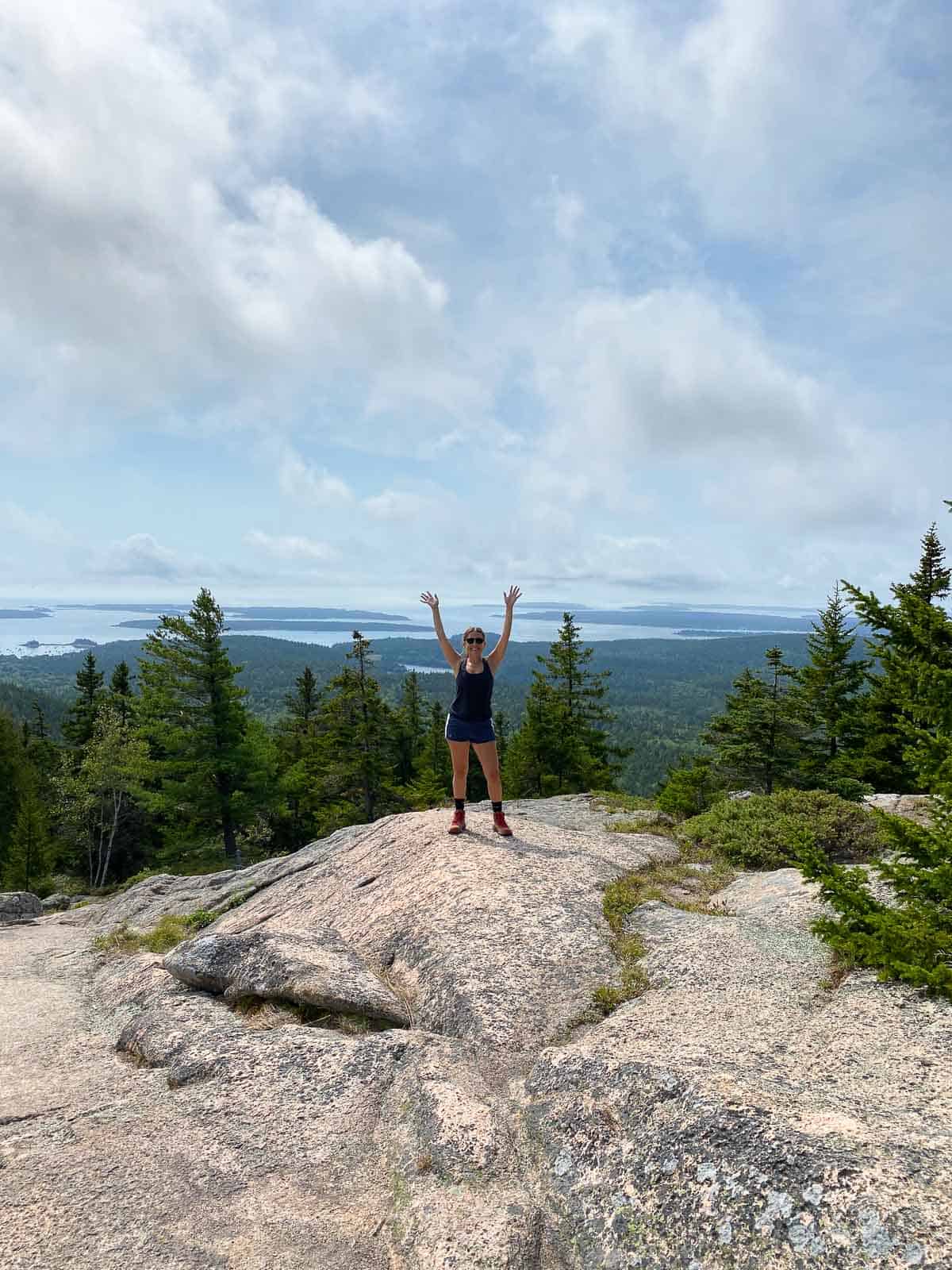 Kara standing on top of a rock on Pemetic Mountain