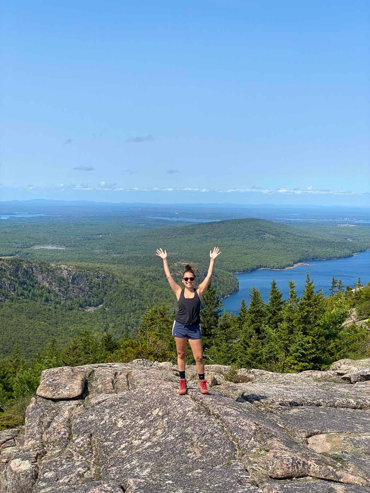 Kara standing on top of a rock on Pemetic Mountain