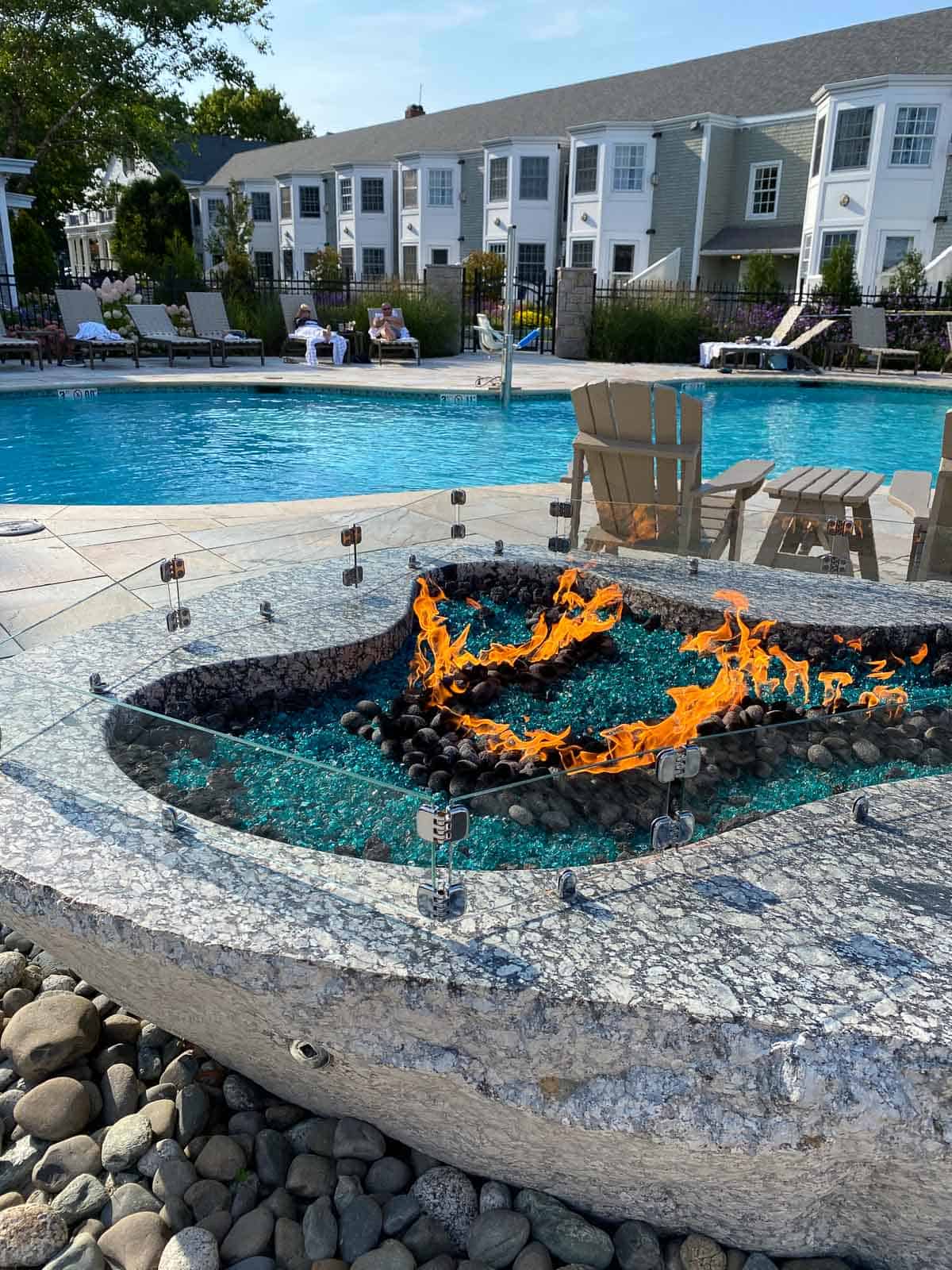 fireplace next to pool outside of hotel
