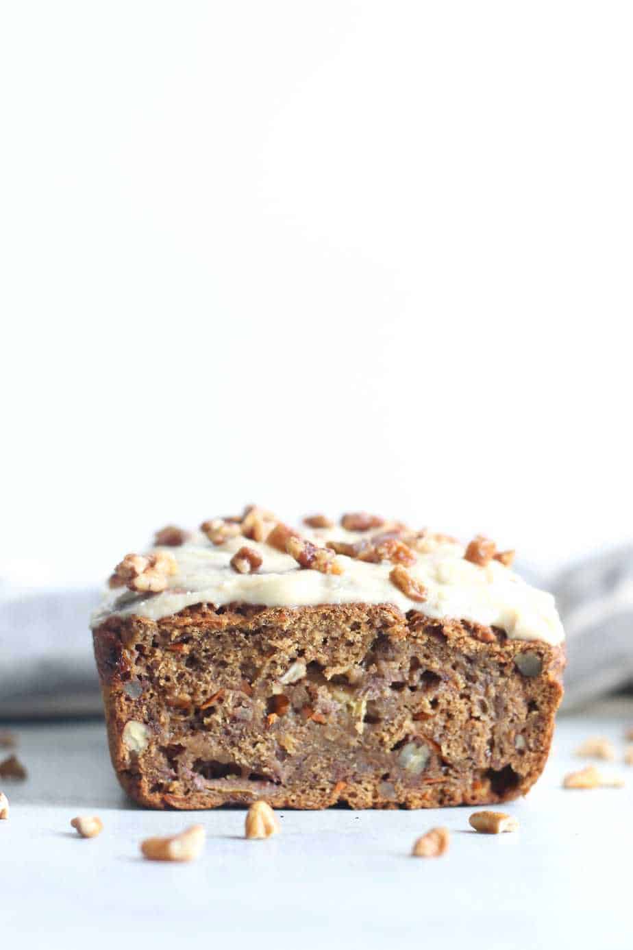 chai spiced carrot banana bread with homemade icing and walnuts for garnish