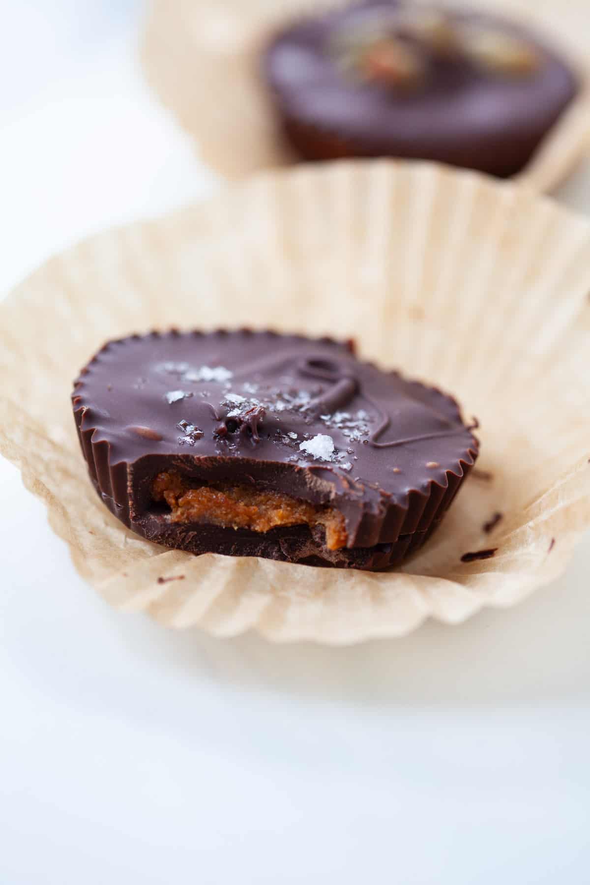 Pumpkin Almond Butter Cup in a cupcake wrapper with bite missing