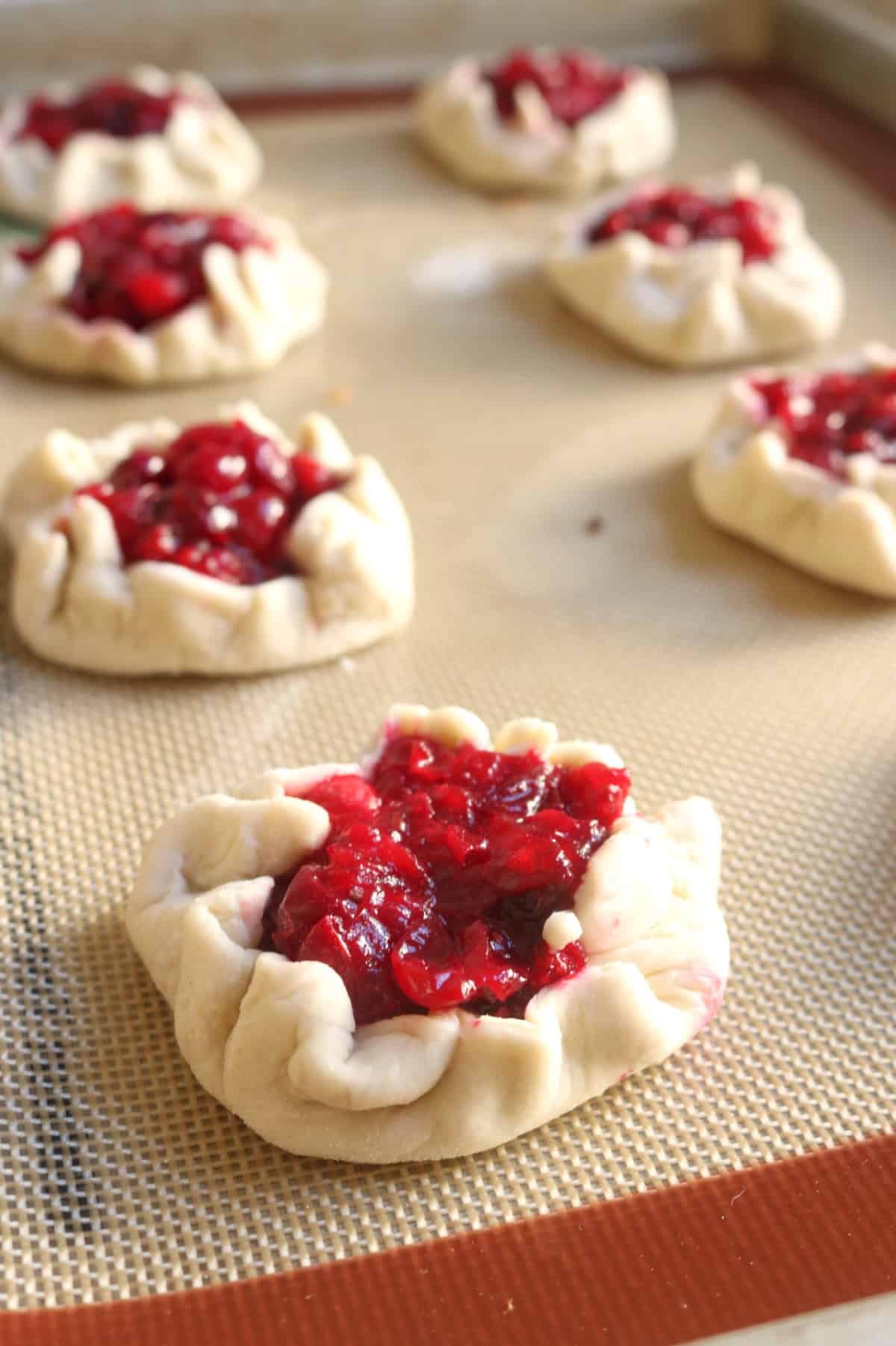 Cranberry Brie Pastry Puffs laid out on baking sheet