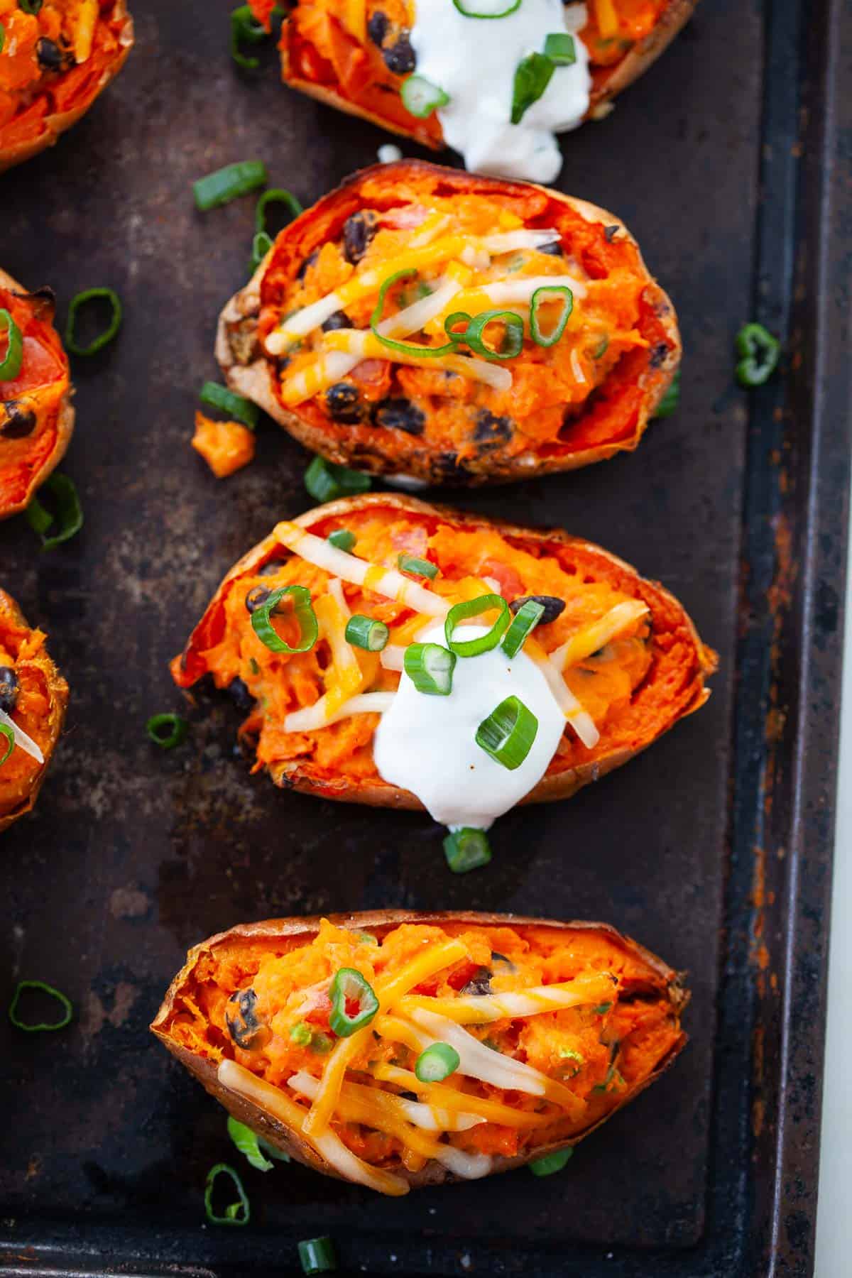 Sweet potato skins with black beans, green onions, vegan shredded cheese, and vegan sour cream.