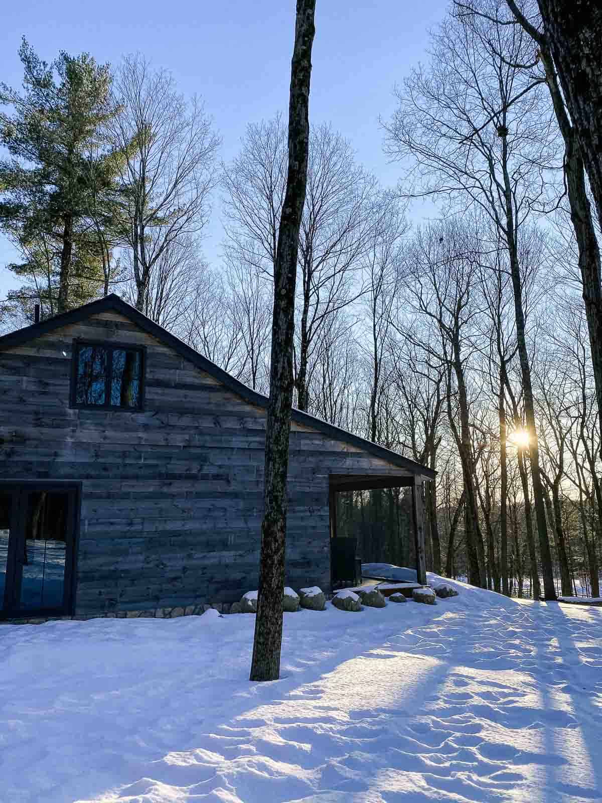 side view of the lodge at june farms at sunset in the winter with snow on the ground