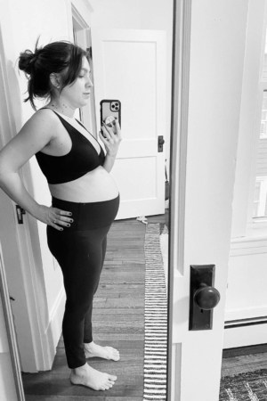 kara lydon second trimester pregnancy side profile mirror selfie pregnant journey yoga pants sports bra