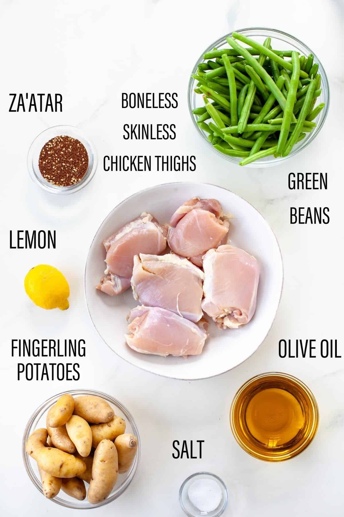 ingredients for sheet pan chicken potatoes and green bean za'atar fingerling potatoes white background