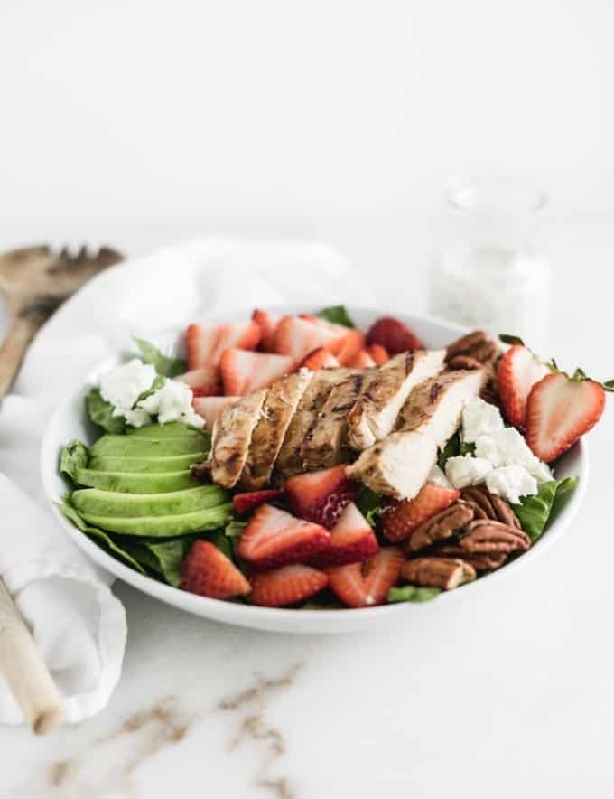 strawberry avocado salad with grilled chicken, avocado, and pecans