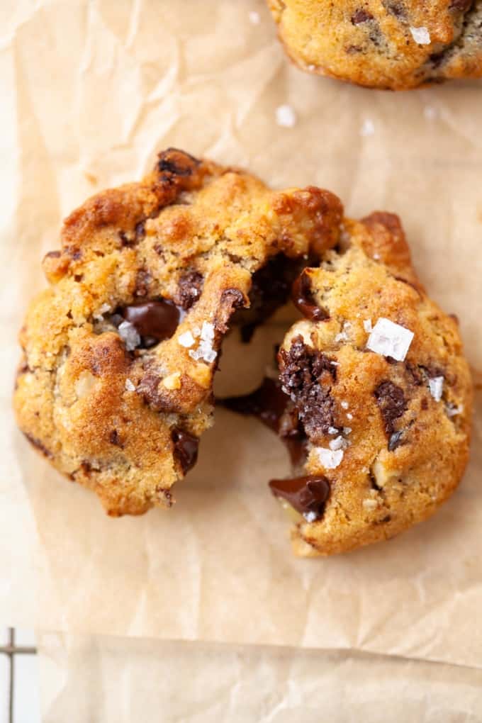 close up air fryer chocolate chip cookie with sea salt broken in half melted chocolate