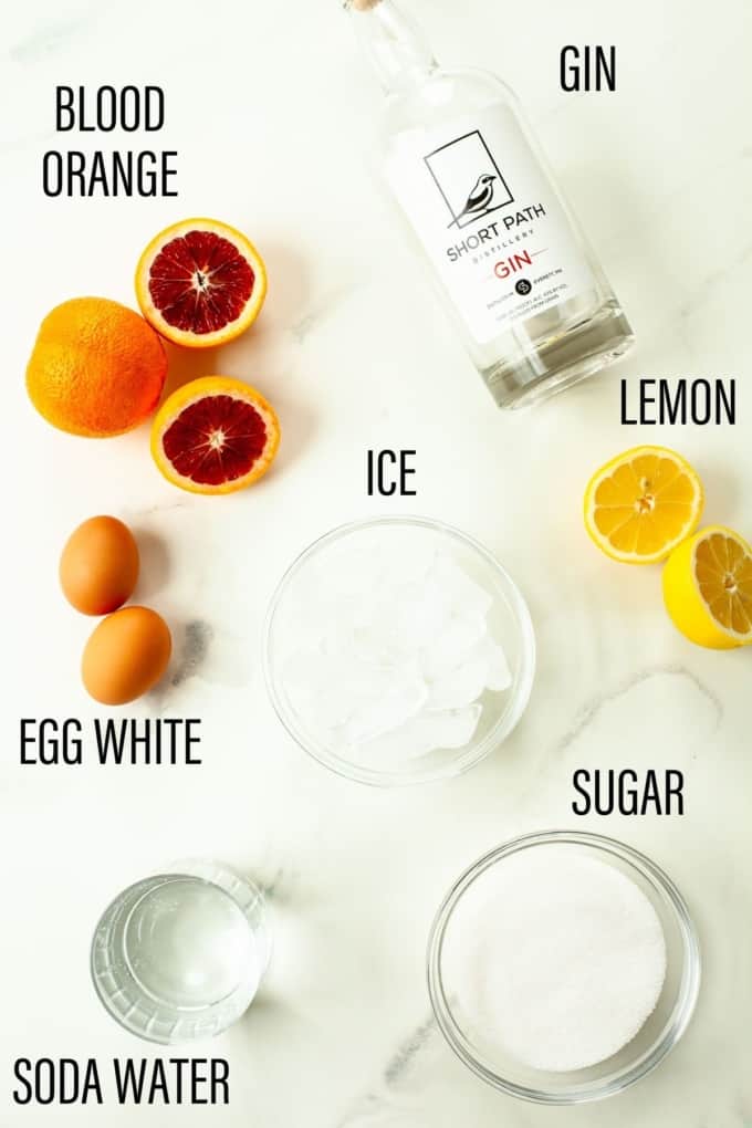 Cocktail ingredients laid out on marble surface
