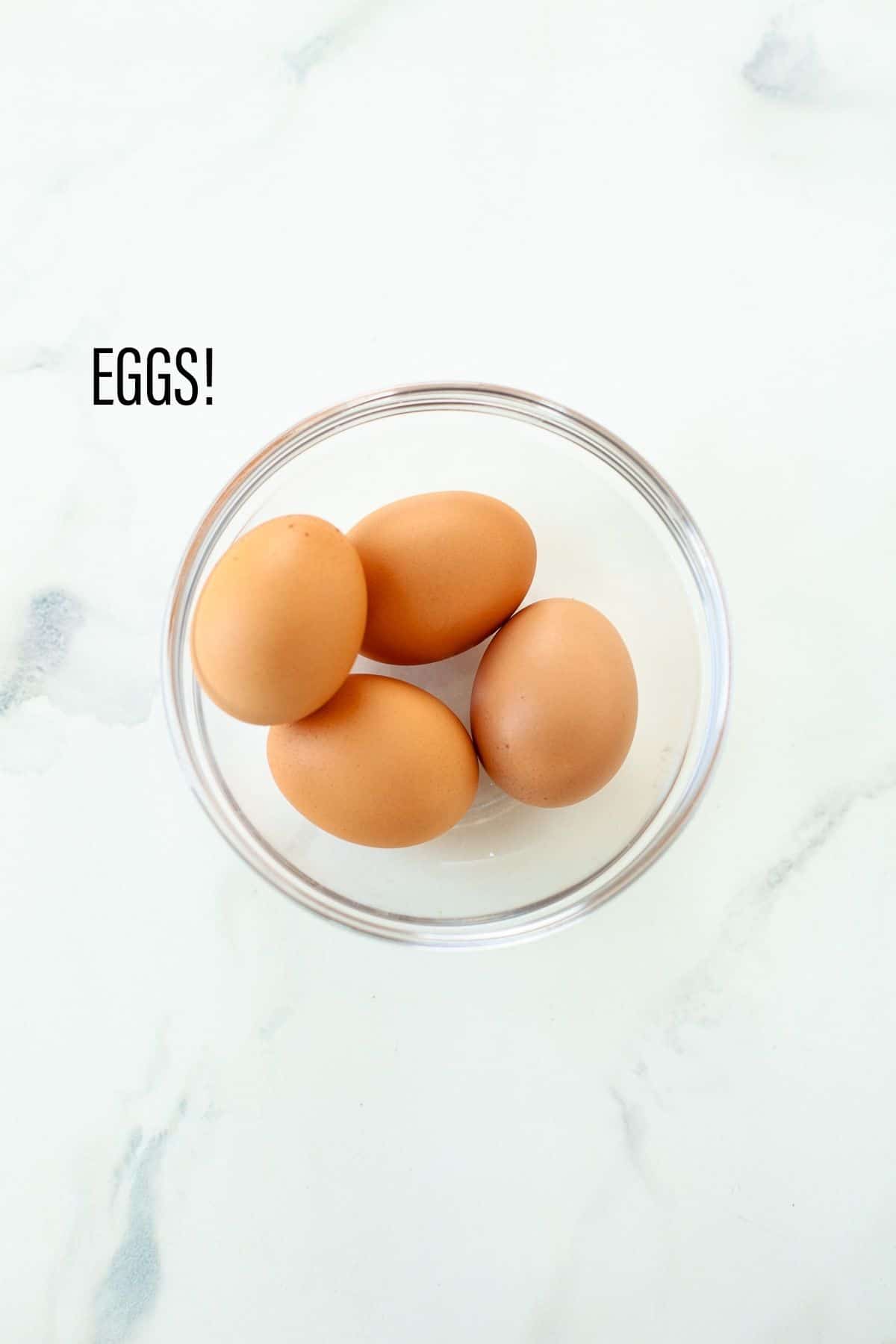 ingredients: eggs in clear bowl, white background