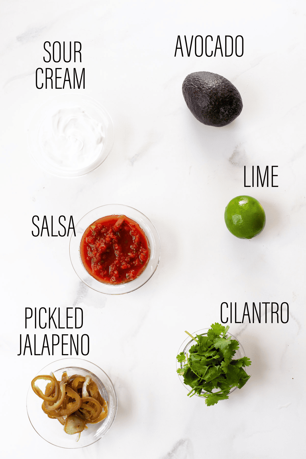 graphic showing toppings for vegetarian nachos with text overlay on marble background