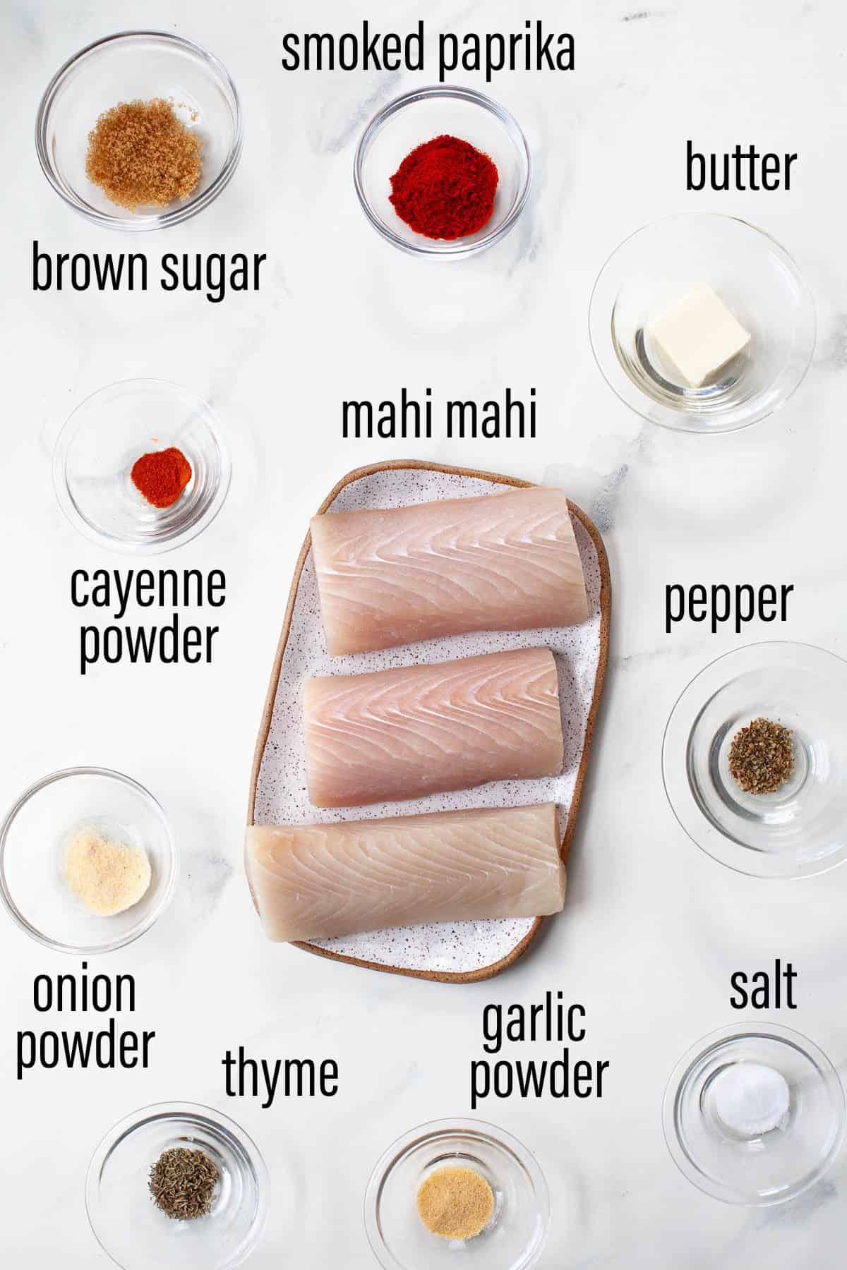 graphic of ingredients for blackened mahi mahi on marble surface with black text overlay