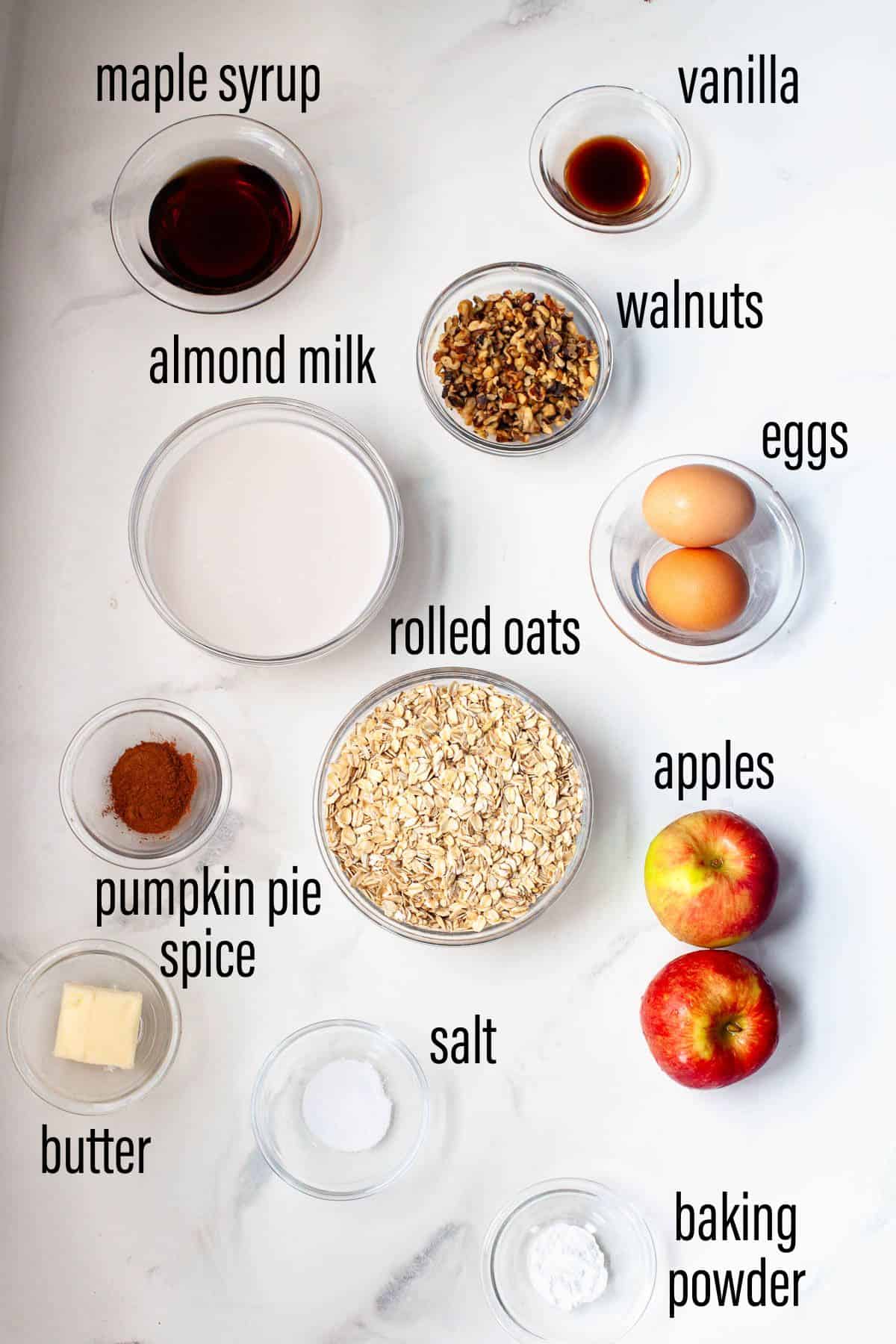 graphic of ingredients for apple pie baked oatmeal on marble surface with black text overlay