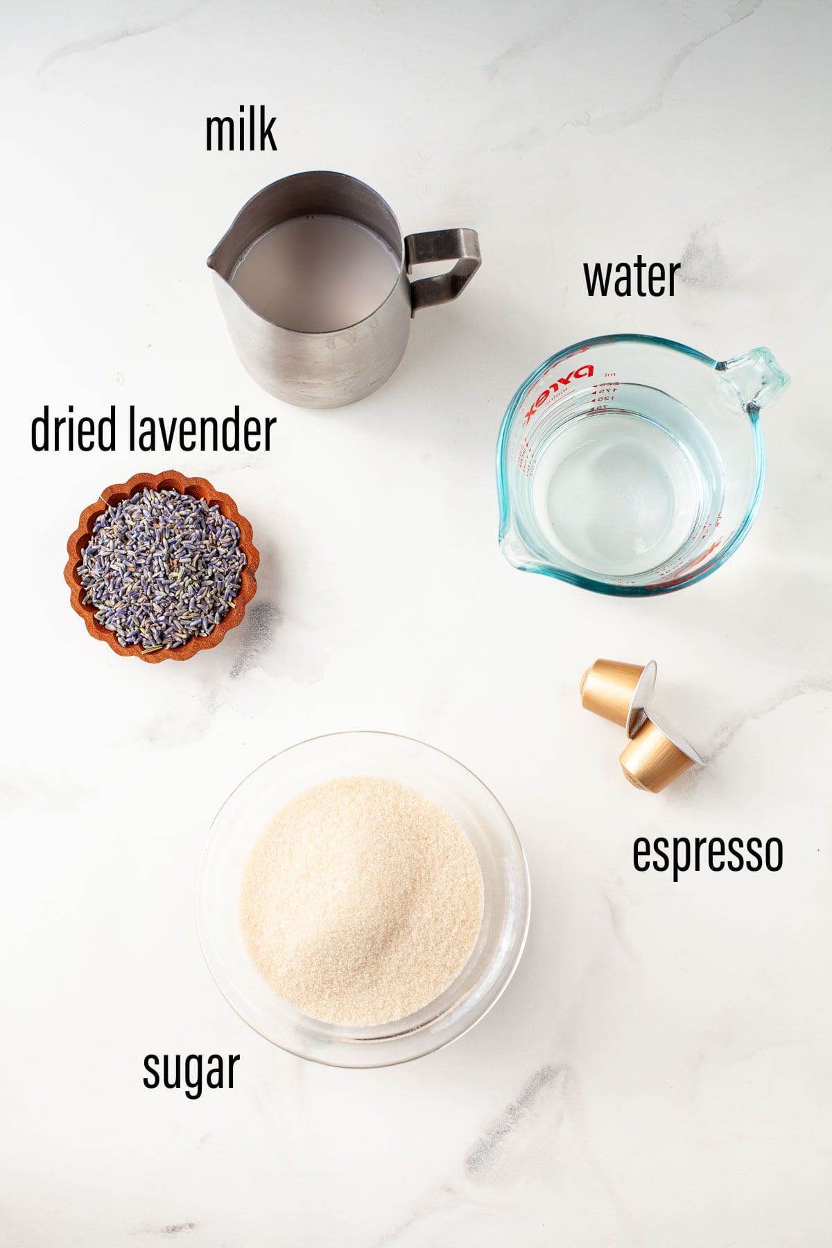 graphic of ingredients for lavender latte on marble surface with black text overlay.