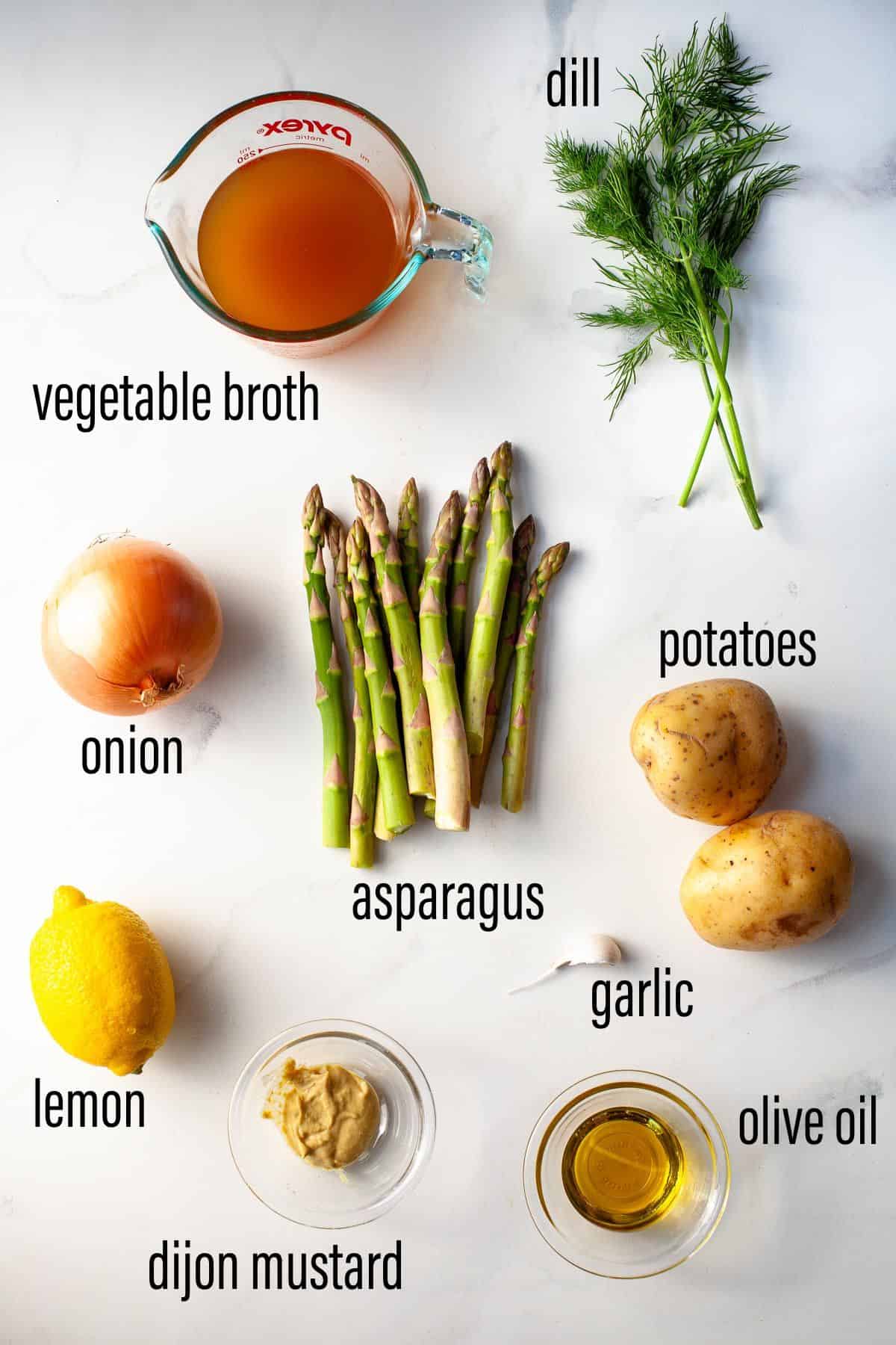 graphic of ingredients for vegan asparagus soup on marble surface with black text overlay.