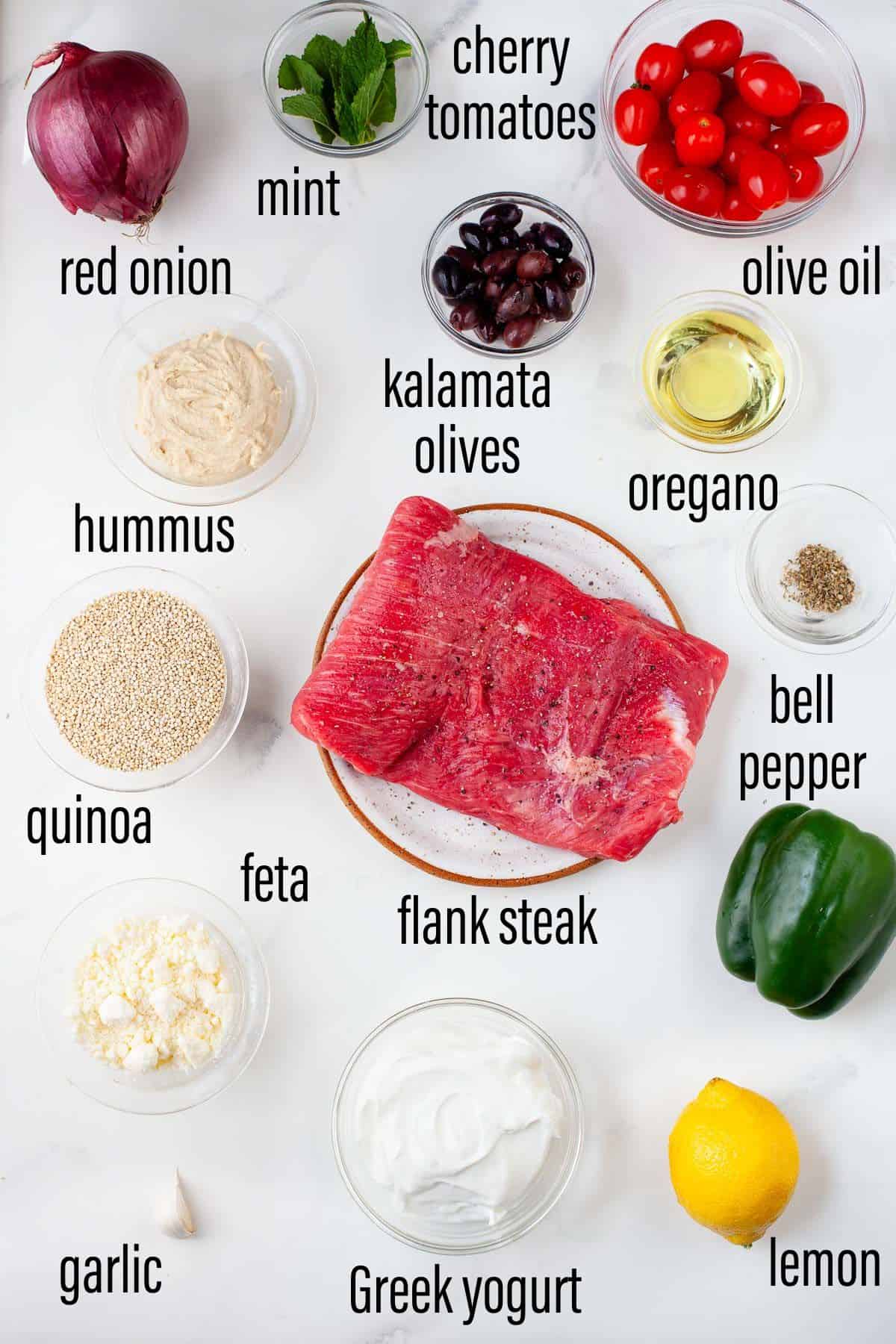 graphic of ingredients for mediterranean steak grain bowl on marble surface with black text overlay.