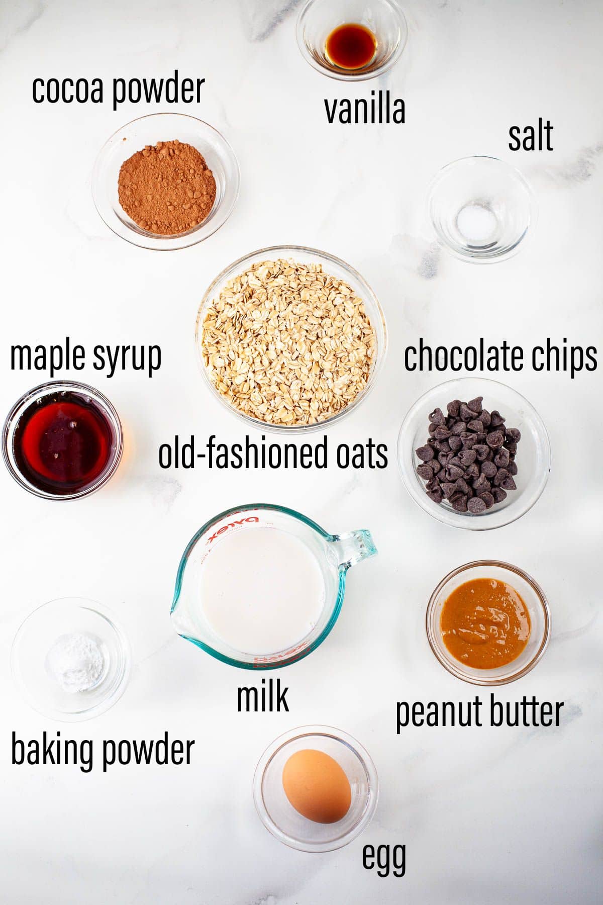 graphic of ingredients for chocolate baked oatmeal on marble surface with black text overlay.
