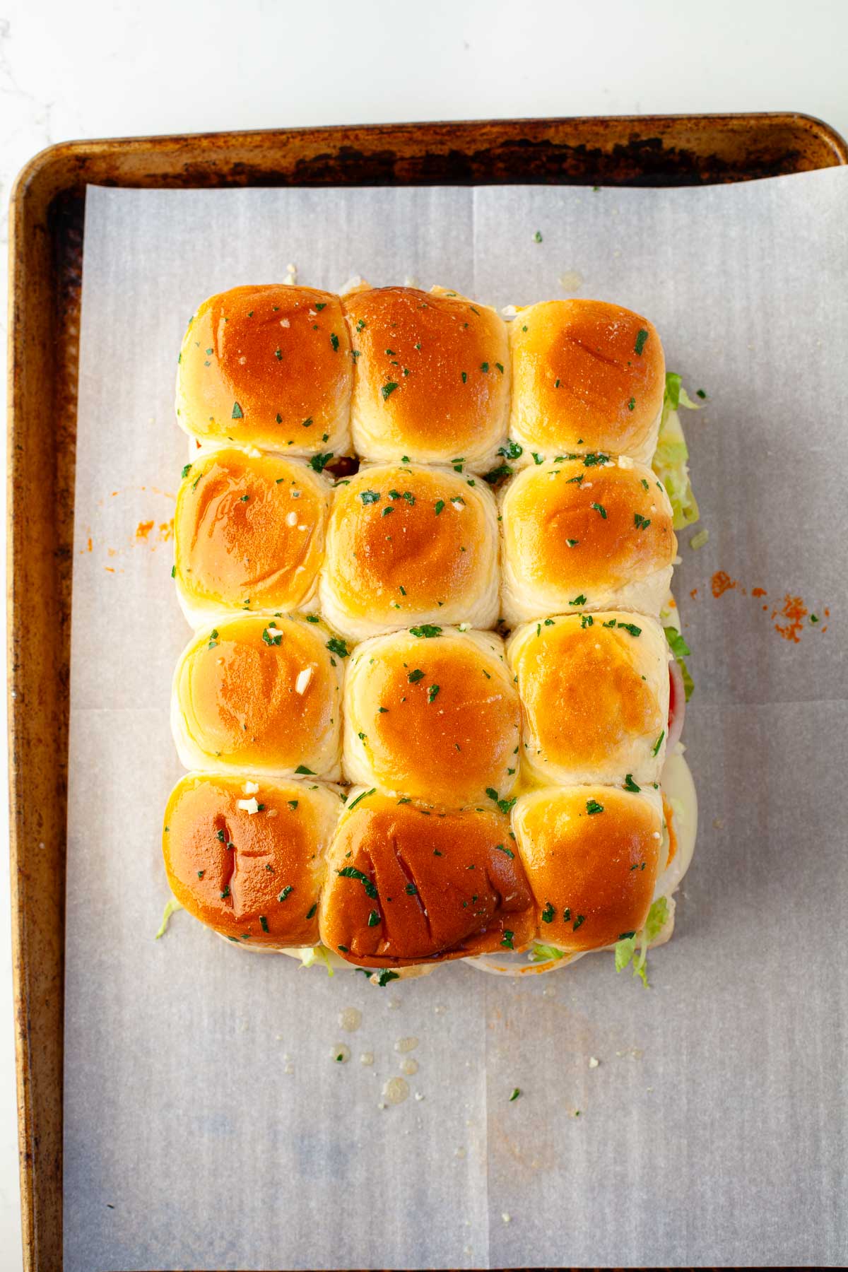 baked buffalo chicken meatball sliders brushed with garlic parsley butter