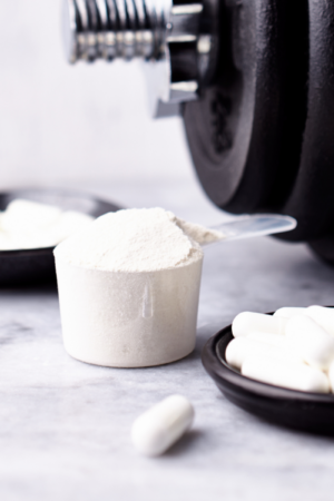 powdered creatine in a measuring cup
